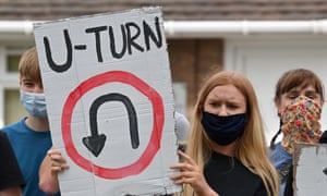 Student holds a banner that says 'U-Turn'